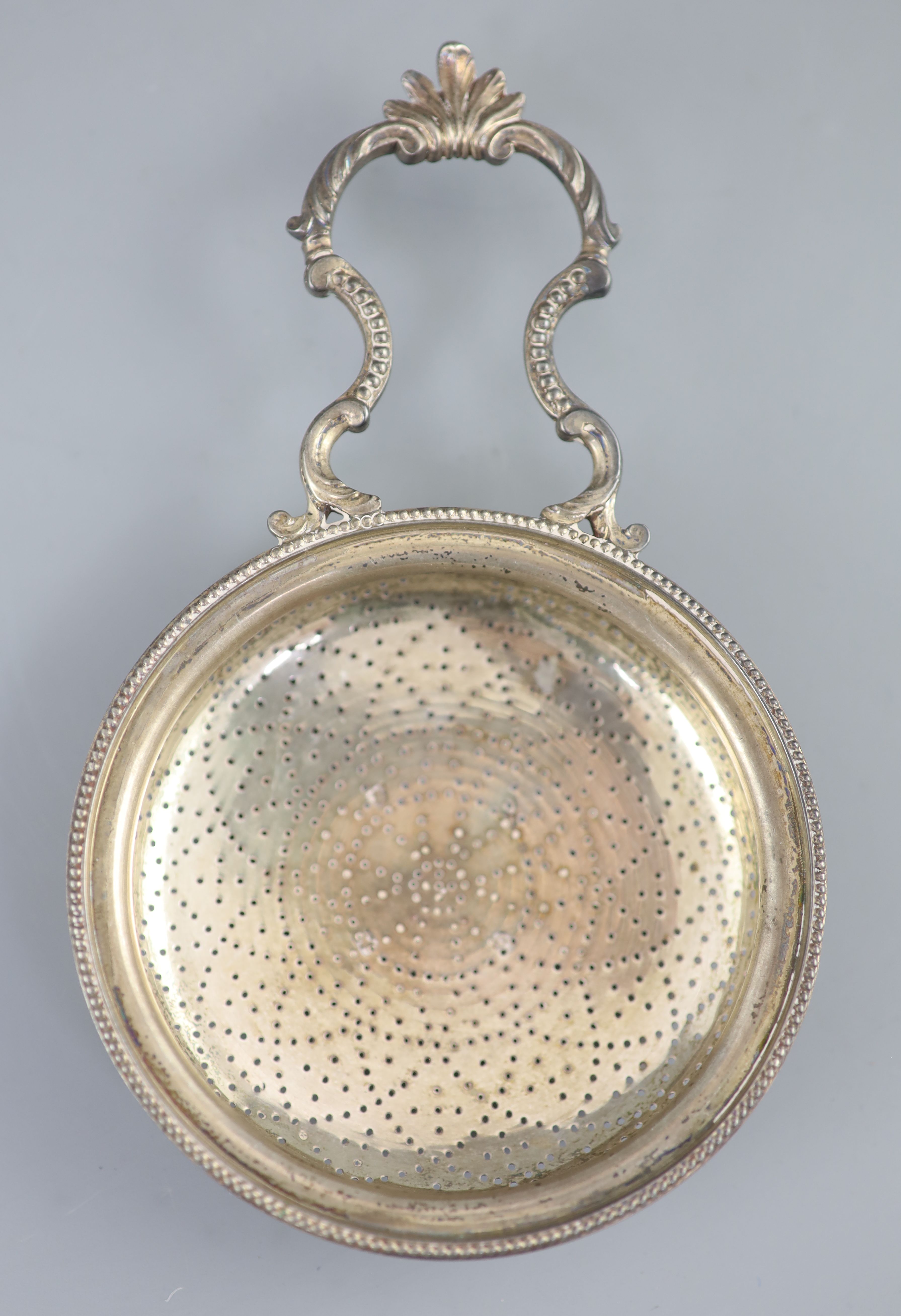 A George III silver single handled lemon strainer, London, 1779,
